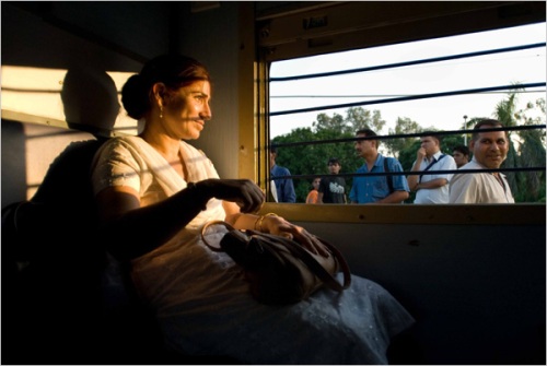 Men peered into the Ladies Special train as it sat idle on the platform in Palwal. | Chiara Goia for The New York Times